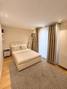 a bedroom with a bed and a large window at Spacious 3BR Lancaster Gate Near Hyde Park in London +4 photos