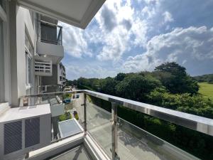 an apartment balcony with a view of the countryside at Serenity Ocean Garden Boracay in Boracay