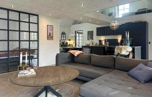 a living room with a couch and a table at Gorgeous Home In Samsø With Wifi in Nordby