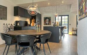 a kitchen and dining room with a table and chairs at Gorgeous Home In Samsø With Wifi in Nordby