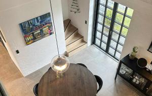 a dining room with a table and a view of a staircase at Gorgeous Home In Samsø With Wifi in Nordby