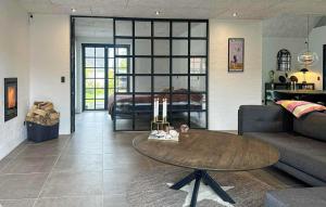 a living room with a table and a couch at Gorgeous Home In Samsø With Wifi in Nordby