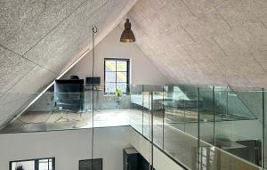an attic office with glass walls and a ceiling at Gorgeous Home In Samsø With Wifi in Nordby +9 photos