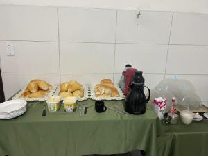 a table with a green table cloth with bread on it at Hotel e Pousada Porto Forte in São Paulo +16 photos