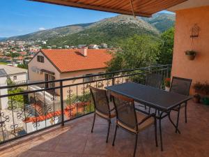 a black table and chairs on a balcony with a view at Apartments Ivka & Garden in Senj