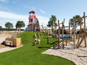 a playground with a lighthouse on top of a hill at Feriendorf Rugana - Klassik 1-Raum Ferienwohnung mit Terrasse B59 in Dranske