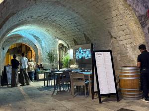 a wine cellar with a table and chairs and a sign at Casa di Sunshine in Ragusa