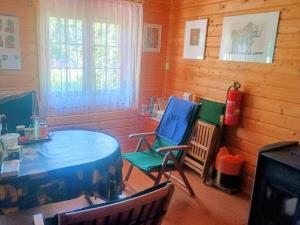 a room with a table and chairs and a fire hydrant at Holzhaus Rheingoldstraße 49a in Urbar