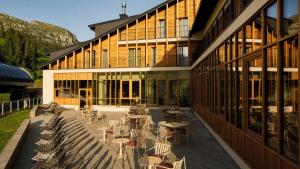 a building with tables and chairs in front of it at Rifugio Colere 1600 by Cloud 7 in Colere