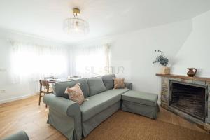 a living room with a couch and a fireplace at Los Sauces By Silastur in Villaviciosa +29 photos