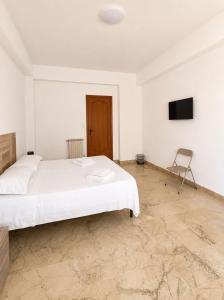 a bedroom with a bed and a tv on the wall at Harbor Elegance Estate in Milazzo