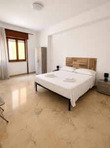 a bedroom with a large white bed in a room at Harbor Elegance Estate in Milazzo