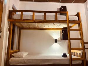a bedroom with two bunk beds in a room at Wave Loom Hostel in Arugam Bay