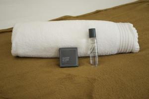 a bottle of water next to a rolled up towel at Gemutlich Guesthouse in Upington +82 photos
