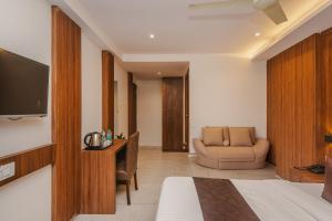 a room with a bed and a couch and a television at Hotel Zillion International Near US Consulate B K C Mumbai Near Mumbai Airport Mumbai in Mumbai +74 photos