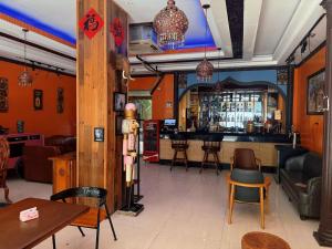 a restaurant with a bar with chairs and a table at Lakeside Inn in Guilin