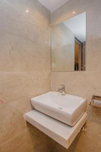 a bathroom with a white sink and a mirror at Hotel Zillion International Near US Consulate B K C Mumbai Near Mumbai Airport Mumbai in Mumbai