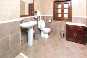 a bathroom with a sink and a toilet and a mirror at Hotel Ivanov Konak i Depadans Palac in Cetinje +70 photos