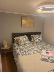 a bedroom with a bed with a blanket and pillows at Pátio de Alfama in Lisbon