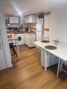 a small kitchen with white appliances and a table at Pátio de Alfama in Lisbon