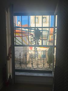 an open window with a view of a building at Pátio de Alfama in Lisbon