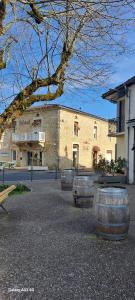 a building with three large barrels in front of it at Escapade cosy - Sauternes & Château à pied in Villandraut