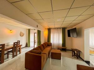 a living room with a couch and a table at Mahagedara Villa Wilpattu in Nochchiyagama