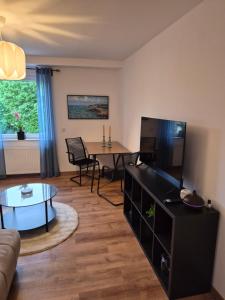 a living room with a couch and a table at FeWo Carolina in Püttlingen
