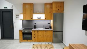 a kitchen with wooden cabinets and a sink at One Lemnos luxury Apartments in Lemnos