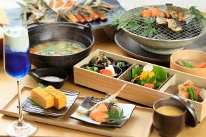 a table with several dishes of food and a drink at 西伊豆 巡り in Ukusu