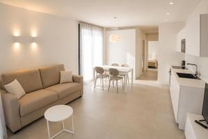 a living room with a couch and a table at Suite Serenissima bilocale con terrazzo frontemare - Agenzia Cocal in Caorle