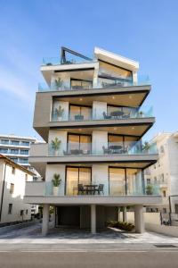 an apartment building with a table in front of it at Suite Serenissima bilocale con terrazzo frontemare - Agenzia Cocal in Caorle