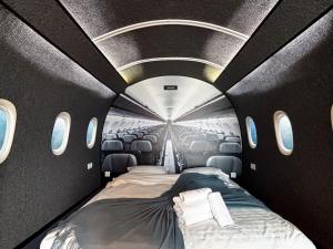 a room with a bed in the middle of an airplane at Airliner Apartment First Class Stay in Cluj-Napoca