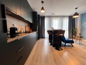 a kitchen with a counter and a table in a room at Airliner Apartment First Class Stay in Cluj-Napoca +24 photos