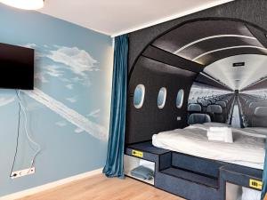 a bedroom with an airplane mural on the wall at Airliner Apartment First Class Stay in Cluj-Napoca