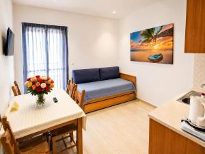 a living room with a couch and a table at Oasis Apartments & Rooms in Plakias