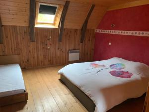 a bedroom with a white bed and a window at La Ruche - Coquelicot in Mauriac