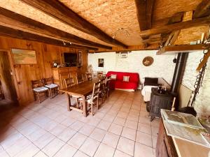 a living room with a table and a couch at La Ruche - Tournesol in Mauriac