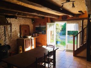 a dining room with a table and a window at La Ruche - Tournesol in Mauriac