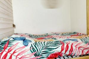 a bed with a colorful comforter in a room at Apartment with a large tree-lined terrace in Sanary-sur-Mer +6 photos