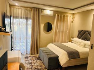 a bedroom with a large bed and a window at Falaza Lodge Jozini in Bhokweni +56 photos