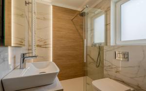 a bathroom with a sink and a shower at Słoneczne Tarasy in Rewal +17 photos
