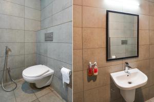 a bathroom with a toilet and a sink at Super Townhouse Gomti Nagar Matiyari in Lucknow