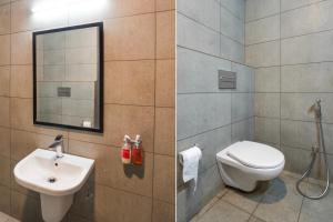 two pictures of a bathroom with a toilet and a sink at Super Townhouse Gomti Nagar Matiyari in Lucknow