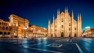 a large building with a cathedral at night at JR Hotels Bocconi Milano in Milan