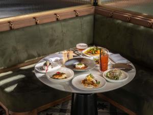 a table with plates of food on it at The William Inglis Mgallery in Warwick Farm