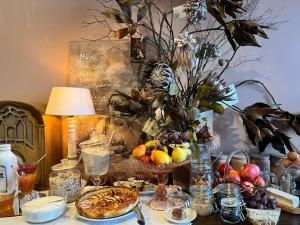 a table with fruit and other food on it at Le Relais du Doubs en Bourgogne in Ciel