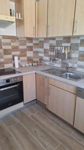 a kitchen with a sink and a stove at Lake Crown in Ogulin