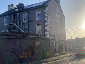 a building with a mural on the side of it at The Loft at Design Bank in Milltown Malbay