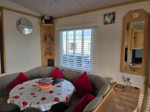 a living room with a couch and a table at Julie and Shaun's in Ingoldmells